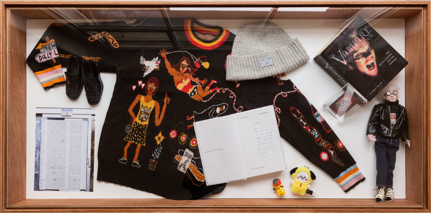 Birds eye view of display cabinet with a jumper and beanie displayed inside