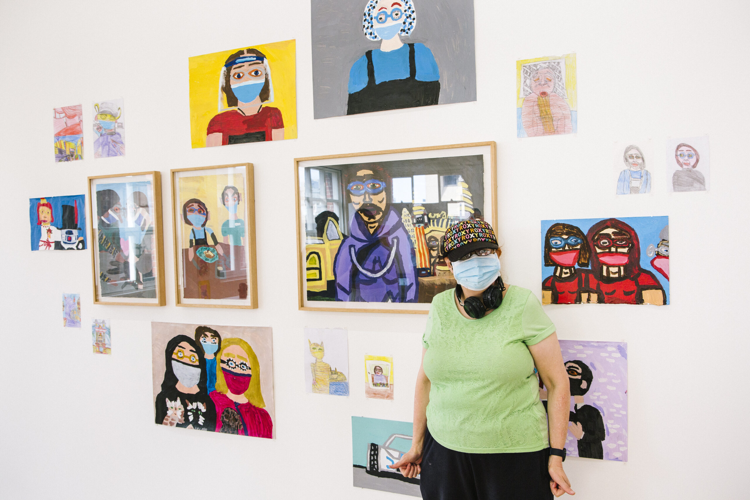 Cathy Staughton standing in front of her art work