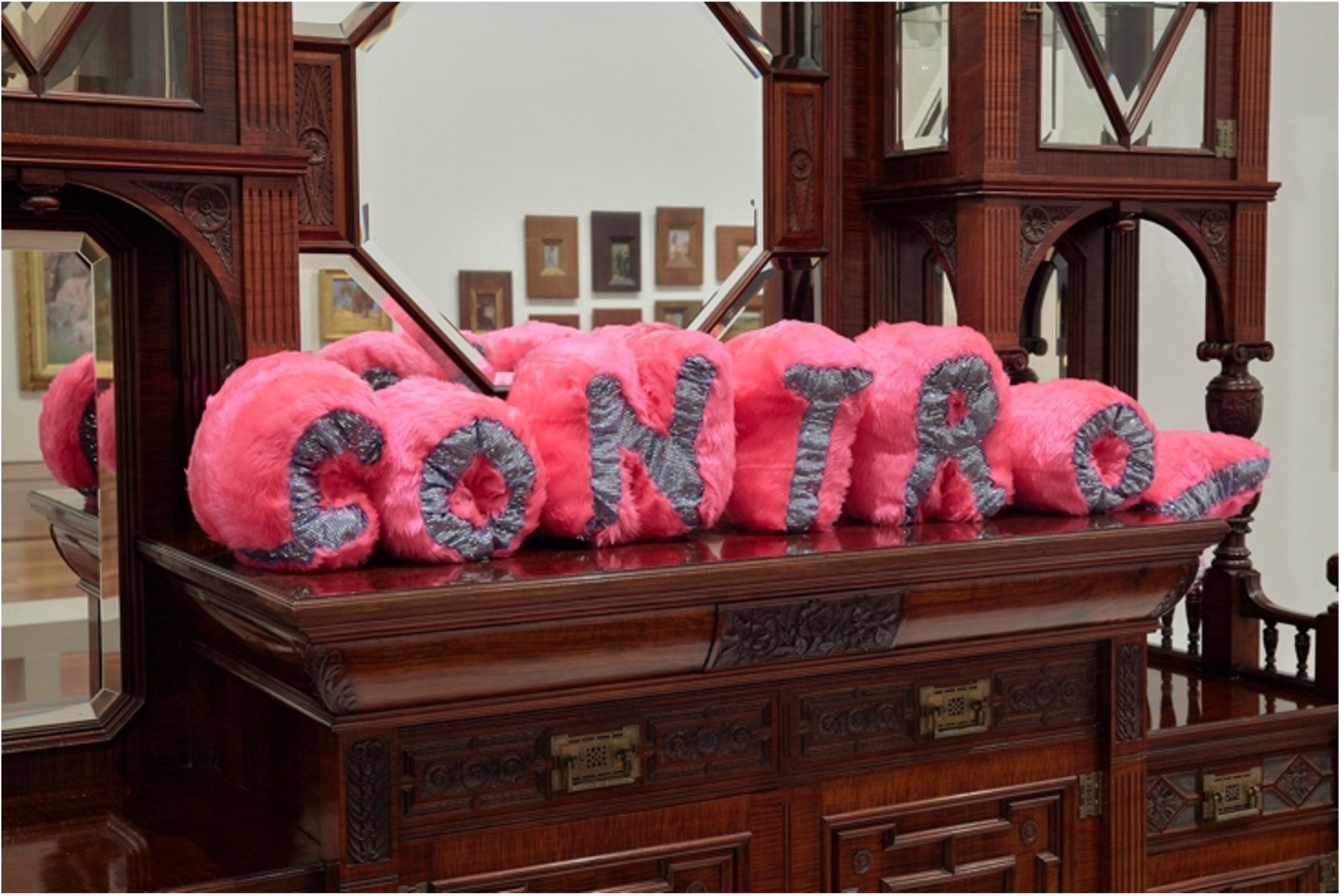 Mark Smith soft sculpture work titled Control pictured installed at Melbourne Now on an antique wooden dresser.