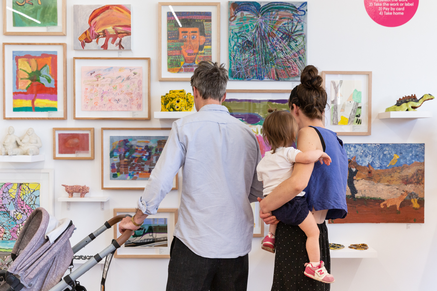 A family looking at artworks at the Arts Project Australia 2022 gala at the gallery