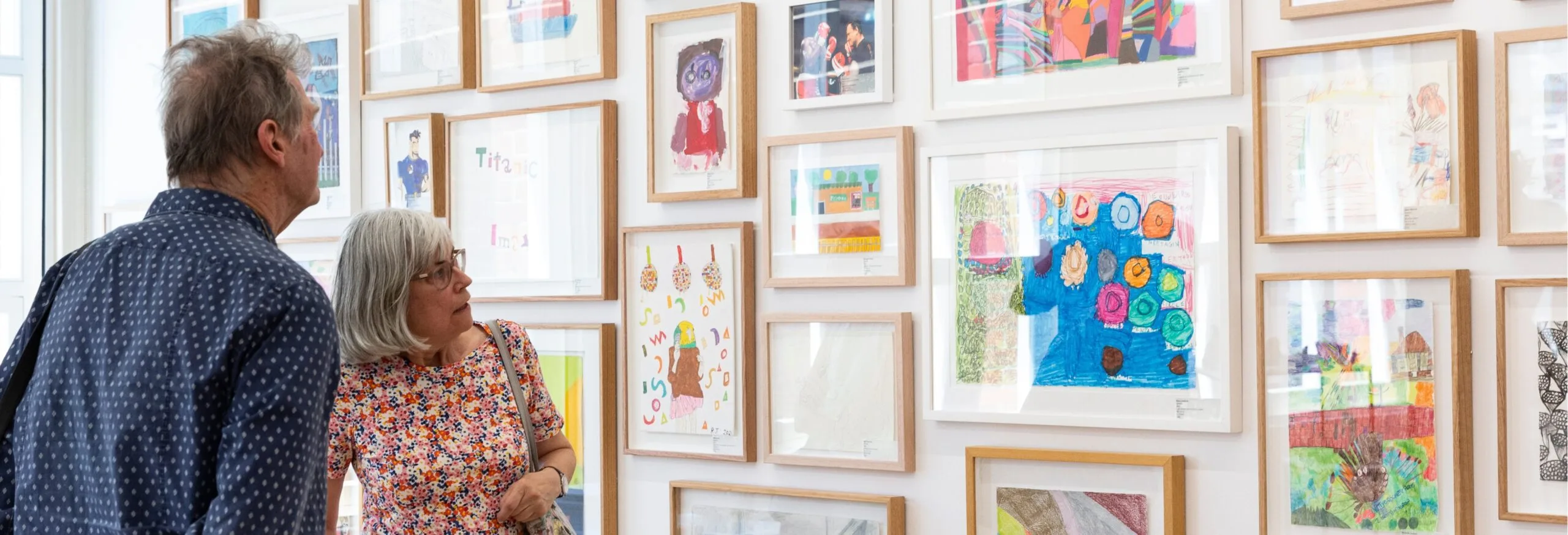 Two visitors view work by APA artists in the Collingwood Gallery